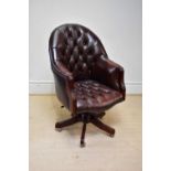 A good reproduction brown leather swivel office chair, upholstered in a button back material.
