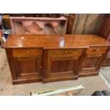A modern hardwood breakfront sideboard with three-drawers above three panelled cupboard doors, width