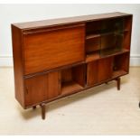 A mid century teak bookcase with pull-down door and an arrangement of sliding doors, width 150cm.
