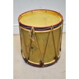 A modern military style drum coffee table, height 63cm, diameter 59cm.