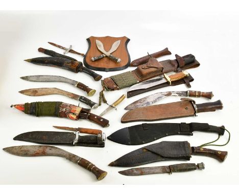 A collection of knives including kukris, Bowie knives, machete, etc (qty).