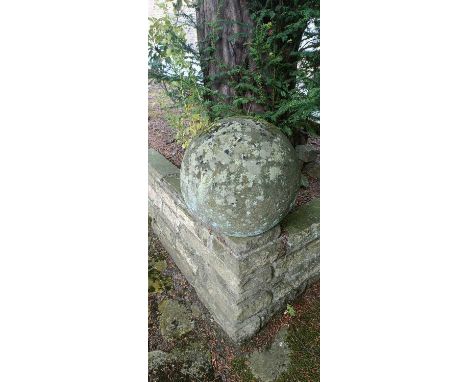 An old stone sphere coping, height 38cm. N.B. This item is sold in situ. The successful buyer will be required to collect dir