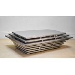 A contemporary stainless steel coffee table of stepped form, length 137cm, depth 53cm, height 41cm.