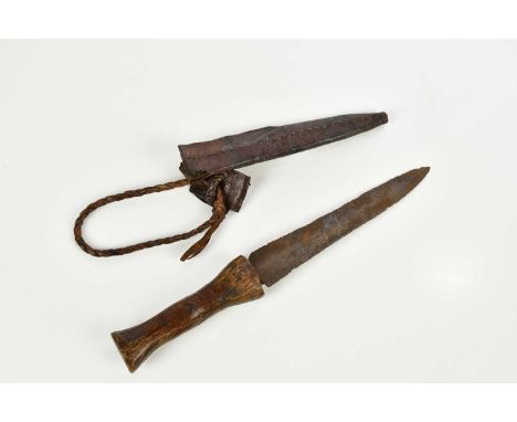 An African / Tribal dagger in leather scabbard, length of blade 15cm, overall length 25cm. 