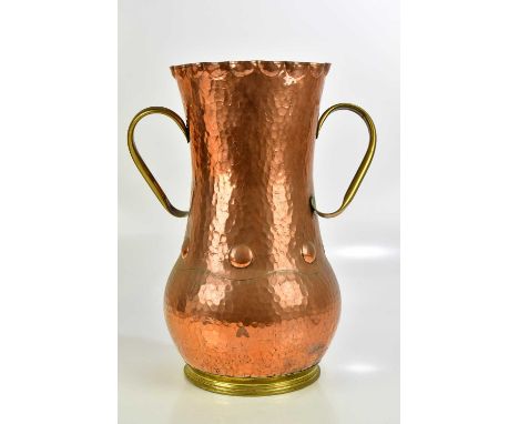 A French Arts and Crafts copper stick stand with twin brass handles, height 51cm.