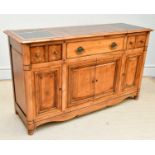 A modern sideboard with pull-out marble inset panels above three drawers and four panelled