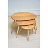 ERCOL; a nest of three Pebble tables, largest height 39cm, width 64cm, depth 44cm.