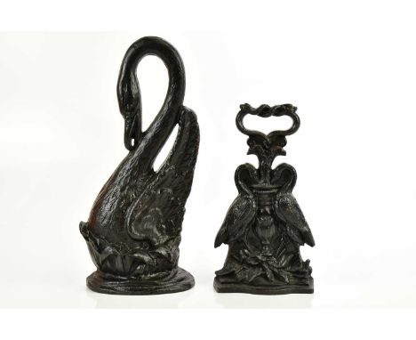 A Victorian cast iron doorstop modelled as a swan, in the style of Coalbrookdale, height 39cm, and a further Victorian stick 