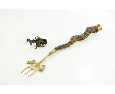 An early 20th century cold painted metal model of a Middle Eastern male whipping a donkey pulling a cart, length 11cm, and a 