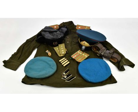 A Russian paratrooper's shirt, with a selection of epaulettes, a leather belt, two caps and an officer's cap and a faux fur h
