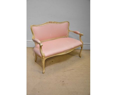A decorative French style sofa for upholstery, with cream frame.