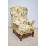 A reproduction Charles II style oak framed wingback arm chair, height 185cm.
