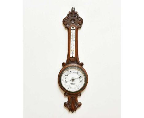 C &amp; R WINTER, PRESTON; a carved oak aneroid barometer, height 83cm.