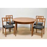 A mid century teak extending circular dining table, height 73cm, diameter closed 117cm, with four
