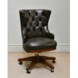 A modern green leather button back swivel office chair.