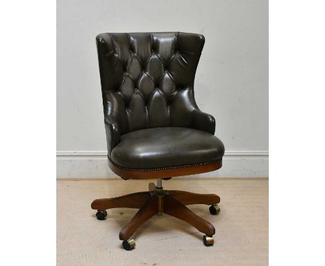 A modern green leather button back swivel office chair.