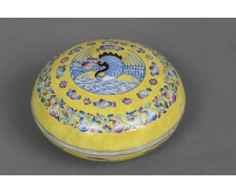 A Chinese porcelain circular box and coverDecorated with a bird within lotus strapwork, blue painted six character Qianlong s