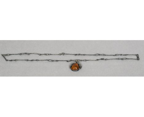 An amber pendant on chainWith leaf form decorations.  The chain approximately 64 cm long.  CONDITION REPORTS: Generally in go