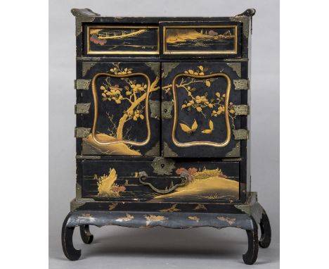 A late 19th/early 20th century Japanese lacquered table cabinetOf typical architectural form with various doors and drawers d