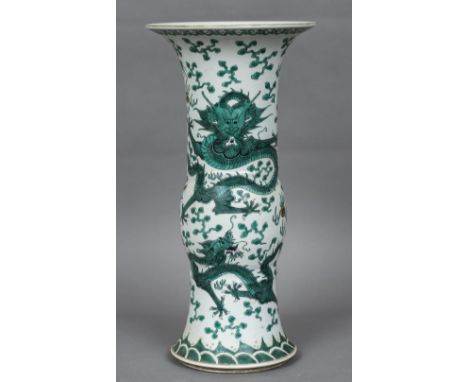 A Chinese porcelain gu vaseOf typical form, decorated with dragons chasing flaming pearls within stylised clouds, red painted