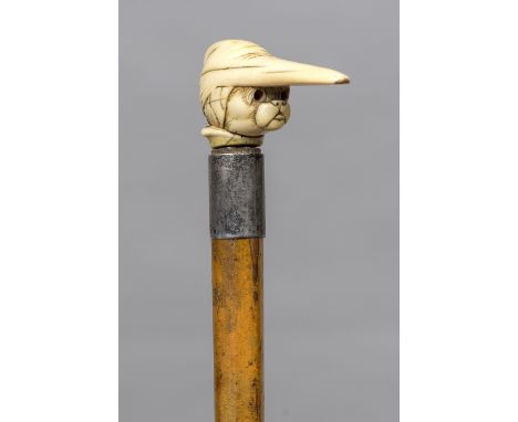 A Victorian ivory handled walking stickThe handle formed as a dog wearing a nightcap.  88.5 cm long.  CONDITION REPORTS: Some