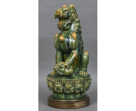 A Chinese pottery figure of a temple lionModelled seated, playing with a cub, on plinth base.  60 cm high. CONDITION REPORTS: