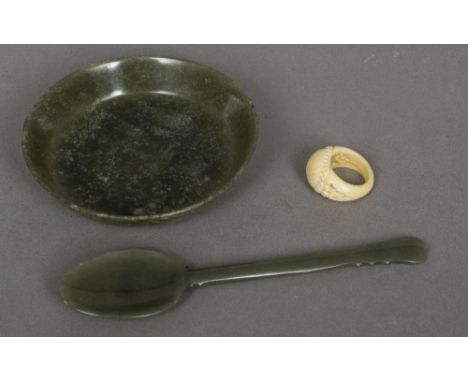 A Mughal style carved spinach jade dish and spoon With arabesque finial; together with a 19th century Indian carved ivory arc