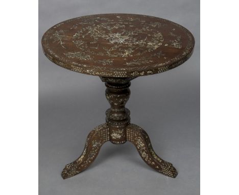 A late 19th century Chinese mother-of-pearl inlaid hardwood tripod tableThe circular top profusely inlaid with various object