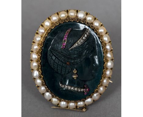 A 19th century French gold mounted, diamond, ruby and pearl set carved hardstone cameo broochThe front carved in relief with 