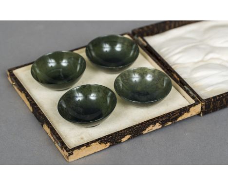 A cased set of four Chinese carved spinach jade bowlsEach 6 cm diameter.  (4) CONDITION REPORTS: All generally in good condit