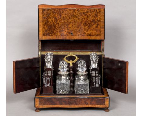 A 19th century French brass inlaid amboyna decanter boxOf serpentine form with removable fitted interior.  34.5 cm wide.  CON