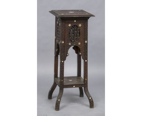 A Liberty type Moorish jardiniere standTypically carved with ebony and mother-of-pearl star form inlays.  90 cm high; 35 cm w