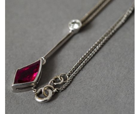 An 18 ct white gold diamond and red stone pendant Supported on an 18 ct white gold chain.  The pendant 3.25 cm long.  CONDITI