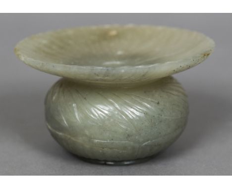 An 18th/19th century Mughal carved jade vaseThe fluted flared rim above a compressed spherical body carved with stiff leaves 