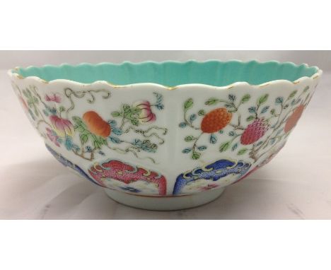 A 19th century Chinese porcelain bowlWith shaped rim above fruiting sprays and floral painted moulded lappet band, red painte