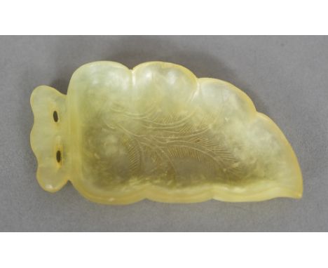 A Chinese carved jade brush washer formed as a leaf10.5 cm wide.  CONDITION REPORTS: Some small chips and fritting, general w