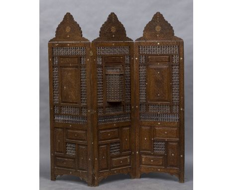 A late 19th/early 20th century North African carved three fold screenWith typical pierced beaded decoration and mother-of-pea