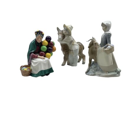 Two Lladro figures, comprising 'Girl with Goat' no.4812 and 'Boy with Donkey' no.1181 together with a Royal Doulton figure, '