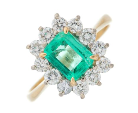 An 18ct gold emerald and brilliant-cut diamond cluster ring, emerald estimated weight 0.85ct, estimated total diamond weight 