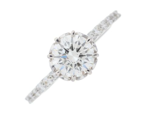 An 18ct gold brilliant-cut diamond single-stone ring, with similarly-cut diamond line shoulders, principal diamond with repor