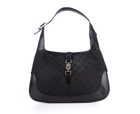 Gucci, a black Jackie handbag, featuring the maker's GG monogram canvas exterior with smooth leather trim, engraved gunmetal 
