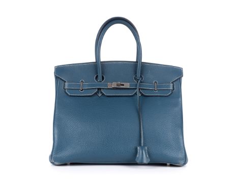 Hermes, a 2003 blue Birkin 35 handbag, featuring a blue pebbled leather exterior, dual rolled handles, top flap and strap clo