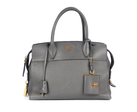Prada, a grey leather handbag, crafted from grey saffiano leather with smooth leather trim, gold-tone hardware, rolled leathe