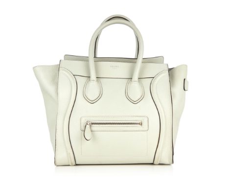 Celine, a Mini Luggage tote, designed with a grained grey leather exterior, featuring expandable leather side wings, a front 