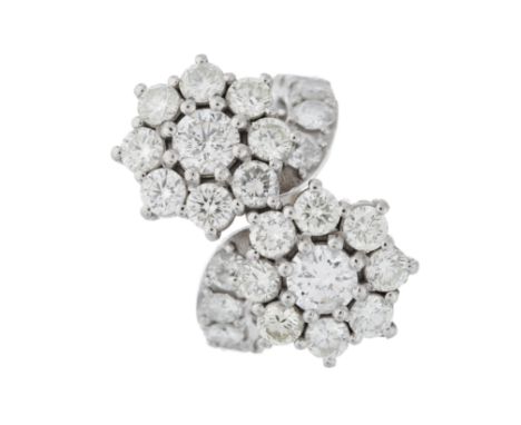 A brilliant-cut diamond floral double cluster ring, with similarly-cut diamond line undulating shoulders, estimated total dia