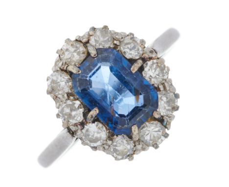 A mid 20th century platinum, rectangular-shape sapphire and circular-cut diamond cluster ring, sapphire estimated weight 1.25