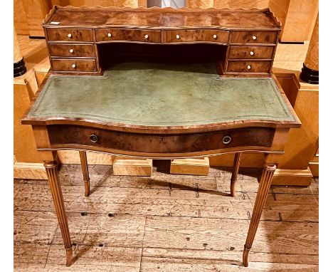 A late Victorian walnut writing table, circa 1900, three quarter gallery top, above on arrangements of interior drawers with 