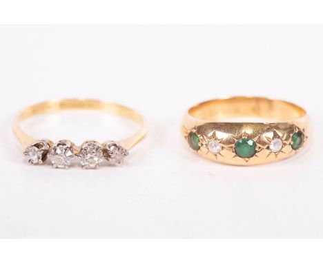 An Edwardian gypsy set 18ct gold ring featuring green and white stones, along with an early 20th century diamond four stone r