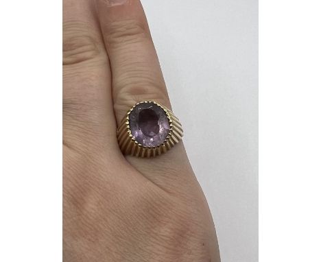 A raised setting textured Amethyst ring. Size K. Gross weight approximately 5.6 grams. (1)
