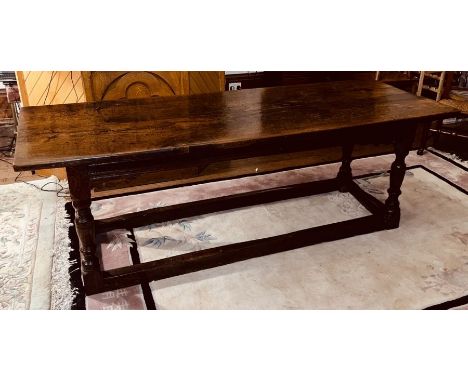 A Charles I oak refectory table, circa 1630, two plank top, raised on baluster on block supports united by rectangular stretc